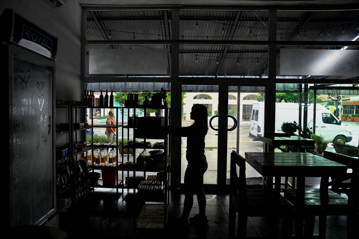 <i>Norlys Perez/Reuters via CNN Newsource</i><br/>A woman works in a restaurant during a blackout in Havana