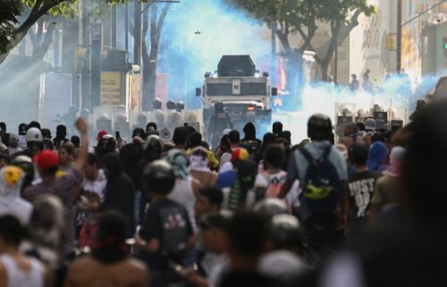 Demonstrators clash with police close to an armoured police car during a protest against Venezuelan President Nicolas Maduro in Caracas