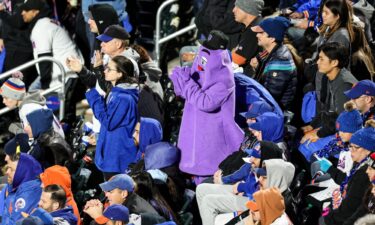 New York Mets fan dressed as Grimace celebrates the team forcing a Game 6 in NLCS.