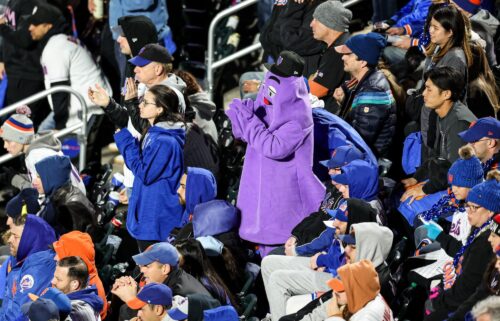 New York Mets fan dressed as Grimace celebrates the team forcing a Game 6 in NLCS.