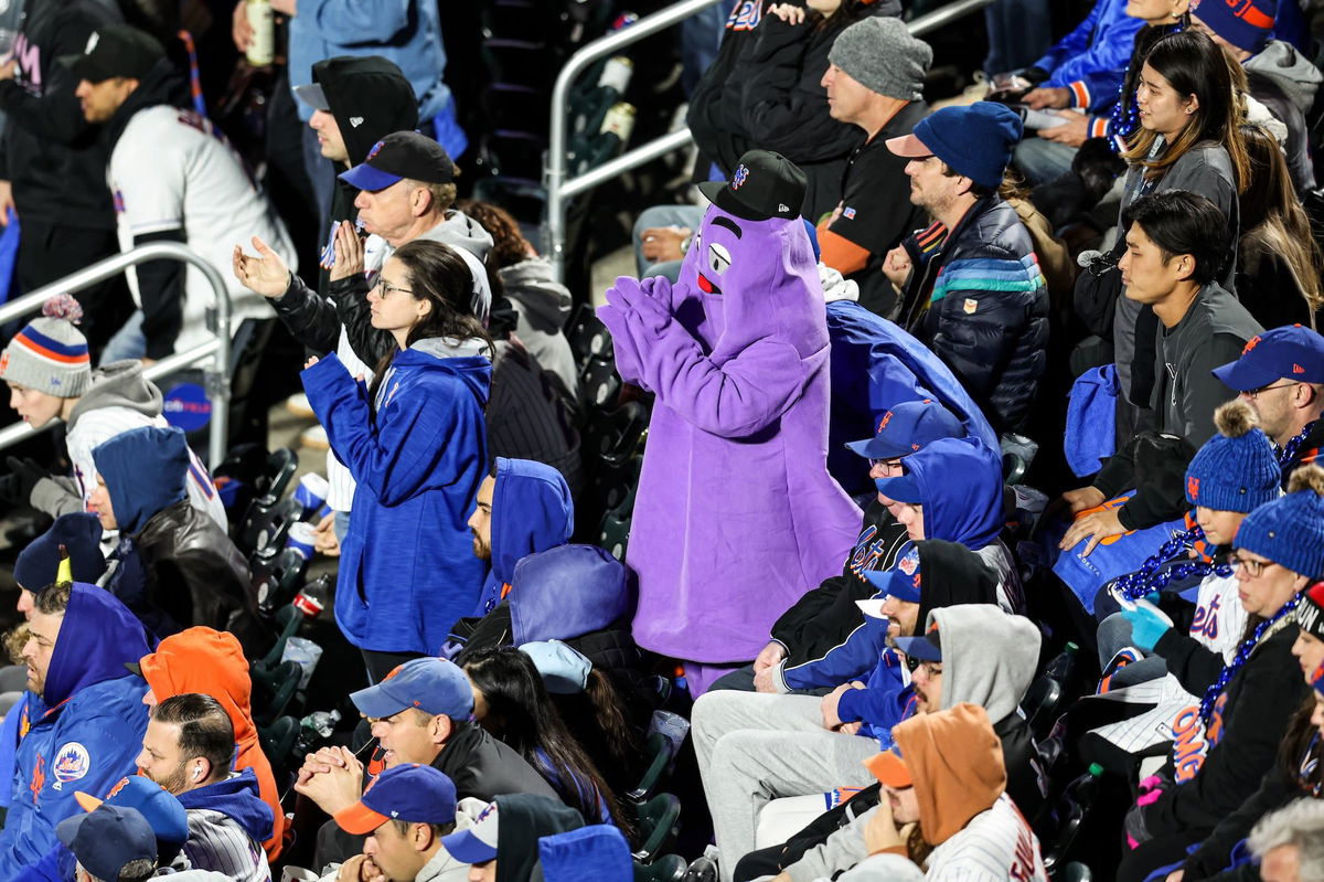 <i>Rob Tringali/MLB Photos/Getty Images via CNN Newsource</i><br/>New York Mets fan dressed as Grimace celebrates the team forcing a Game 6 in NLCS.