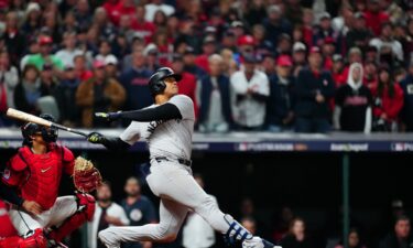 Juan Soto #22 of the New York Yankees hits a three-run home run in the 10th inning during Game 5 of the ALCS.