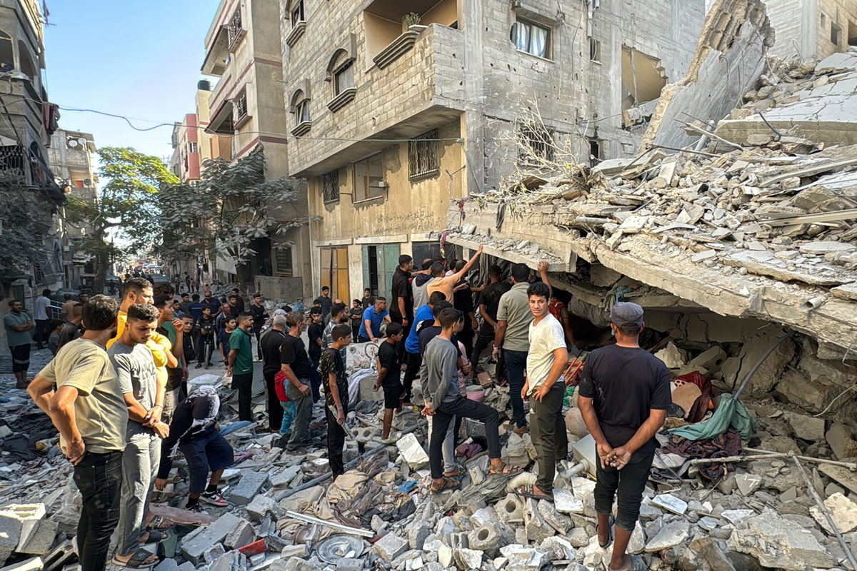 <i>Islam Ahmed/AFP/Getty Images via CNN Newsource</i><br/>Palestinians inspect the damage after an Israeli airstrike the previous night in Beit Lahia