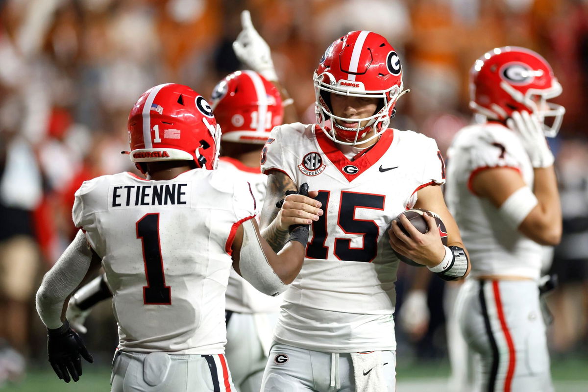 <i>Tim Warner/Getty Images via CNN Newsource</i><br/>Carson Beck #15 and Trevor Etienne #1 celebrate their win.