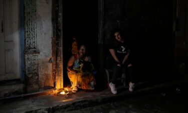 Residents pass the time during a blackout following the failure of a major power plant in Havana