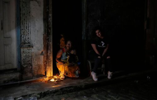 Residents pass the time during a blackout following the failure of a major power plant in Havana