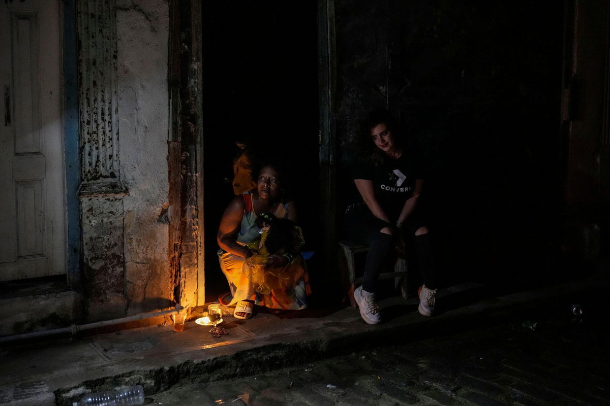 <i>Ramon Espinosa/AP via CNN Newsource</i><br/>Residents pass the time during a blackout following the failure of a major power plant in Havana