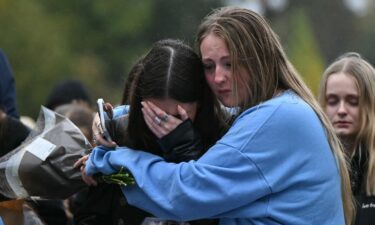 Fans comforting each other while paying tribute to Liam Payne at a memorial held on Sunday in London's Hyde Park.