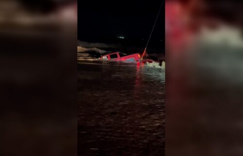 A truck is seen submerged in flood waters in Hagerman