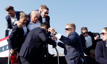 Former President Donald Trump is rushed offstage during a rally on July 13 in Butler