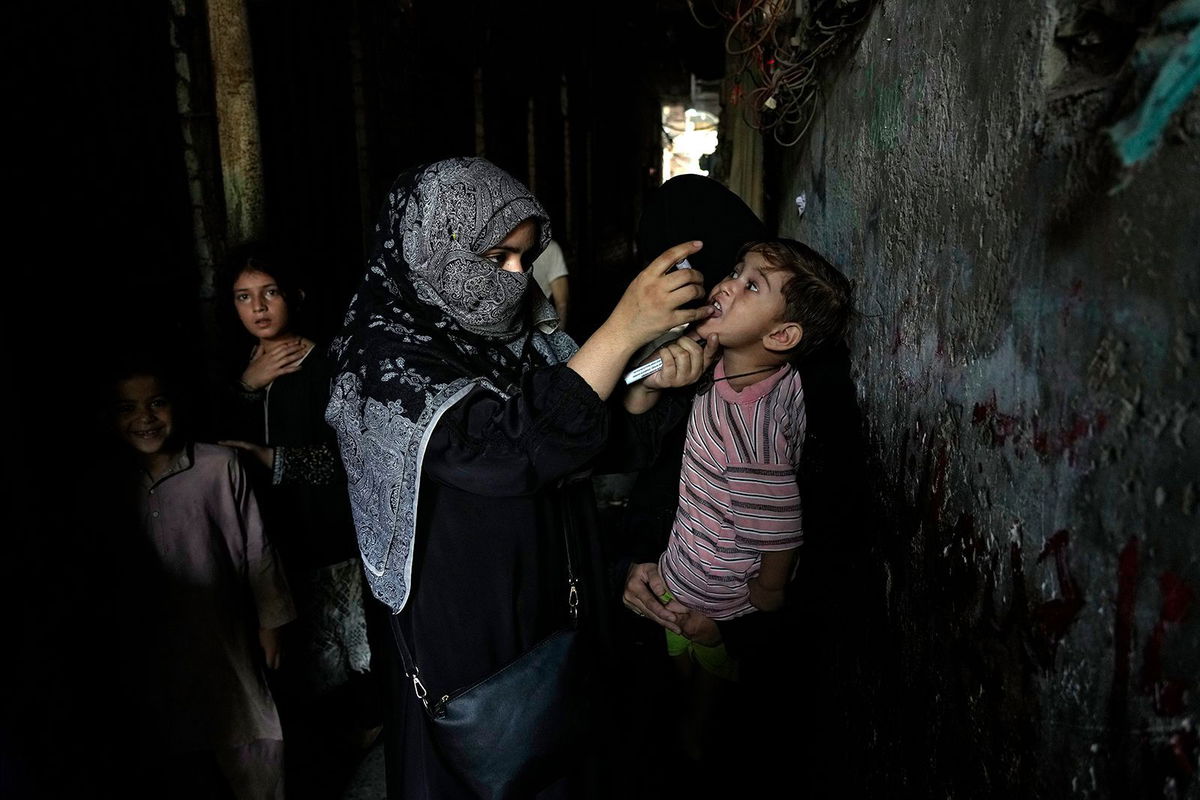 <i>K.M. Chaudary/AP via CNN Newsource</i><br/>A health worker administers a polio vaccine to a child in a downtown area of Lahore