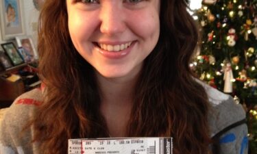 Mikaela Dee poses in 2013 after receiving her very first One Direction concert tickets for the Where We Are Tour.