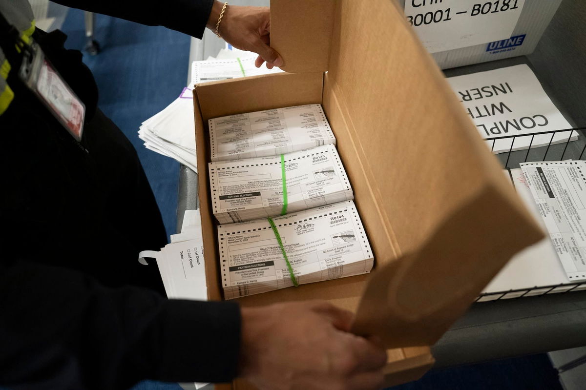 <i>Allison Joyce/Getty Images via CNN Newsource</i><br/>Absentee ballots are prepared to be mailed at the Wake County Board of Elections on September 17