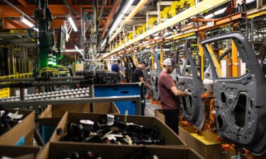 Workers assemble vehicle doors at the General Motors assembly plant in Fort Wayne