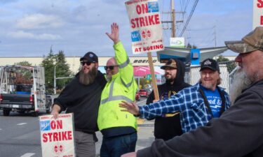 Union machinists wave signs next to the company's factory in Everett