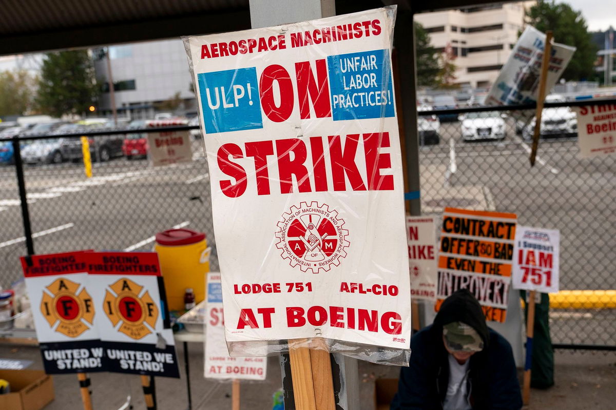 <i>David Ryder/Getty Images via CNN Newsource</i><br/>Boeing workers gather on a picket line during an ongoing strike on October 24 in Seattle.