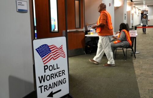 Election workers oversee early election voting at a polling station in Marietta