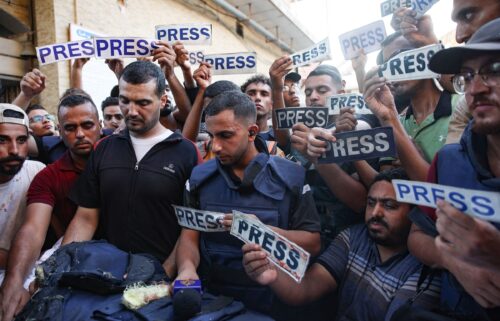 Mourners and colleagues hold 'press' signs around the body of Al-Jazeera Arabic journalist Ismail al-Ghoul