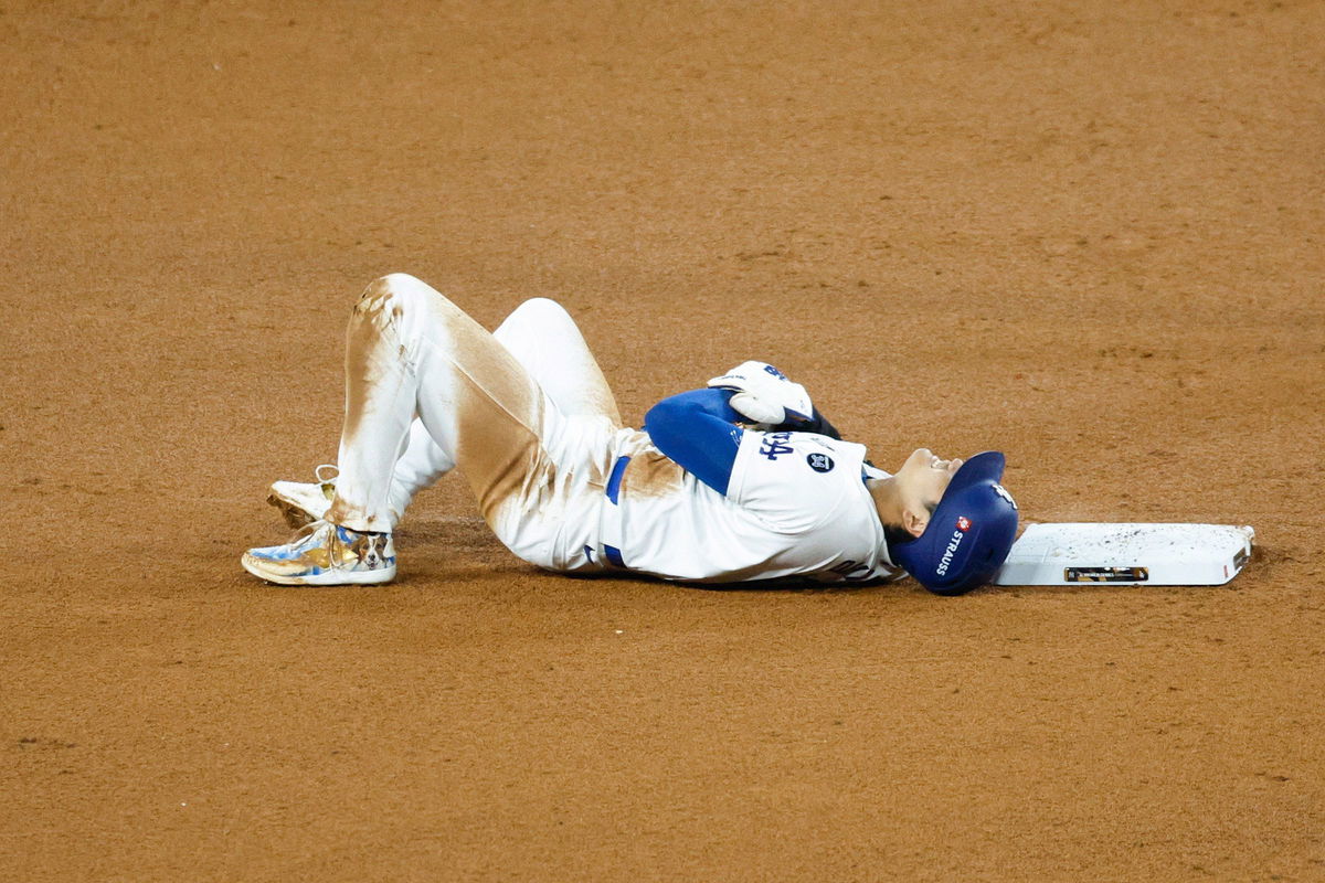 <i>Kevork Djansezian/Getty Images via CNN Newsource</i><br/>Shohei Ohtani of the Los Angeles Dodgers lies on the ground injured after attempting to steal second base in the seventh inning during Game 2 of the 2024 World Series at Dodger Stadium on Saturday in Los Angeles