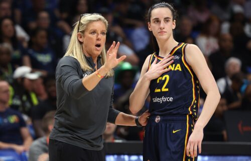 Indiana Fever guard Caitlin Clark talking to head coach Christie Sides during a preseason game.