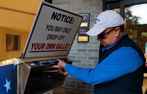 Diego Proano drops off a mail-in ballot on October 15