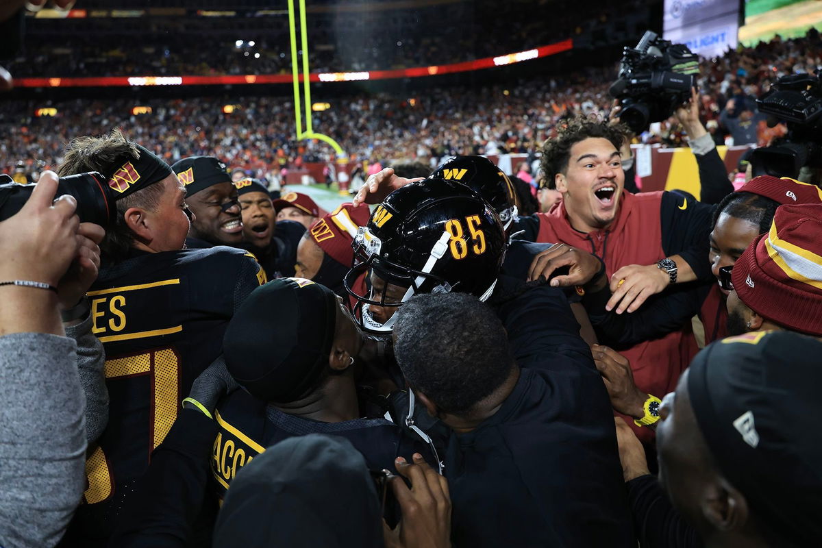 <i>Scott Taetsch/Getty Images via CNN Newsource</i><br/>Washington Commanders players celebrate Noah Brown's game-winning Hail Mary touchdown catch to beat the Chicago Bears.