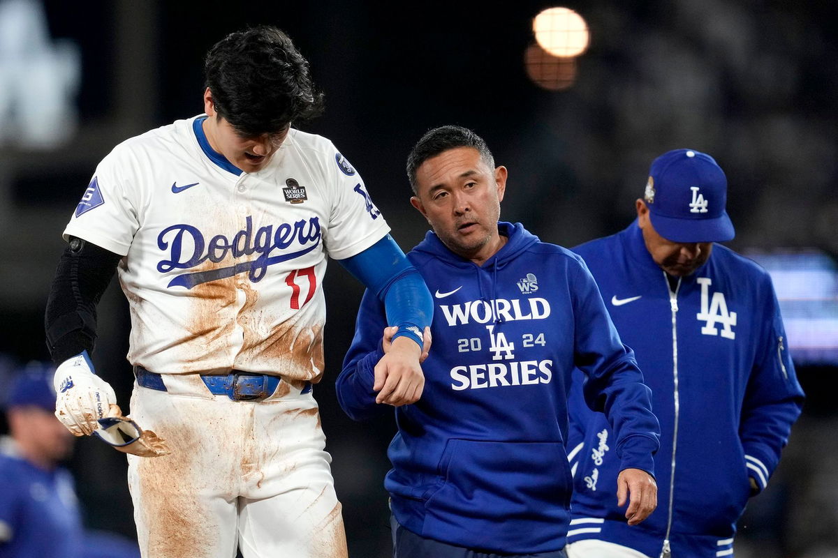 <i>Ashley Landis/AP via CNN Newsource</i><br/>Shohei Ohtani is helped off the field after getting hurt during the seventh inning in Game 2 of the World Series against the New York Yankees.