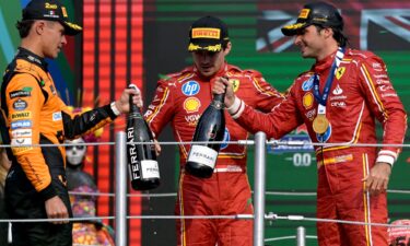 Sainz celebrates on the podium with Lando Norris and teammate Charles Leclerc.