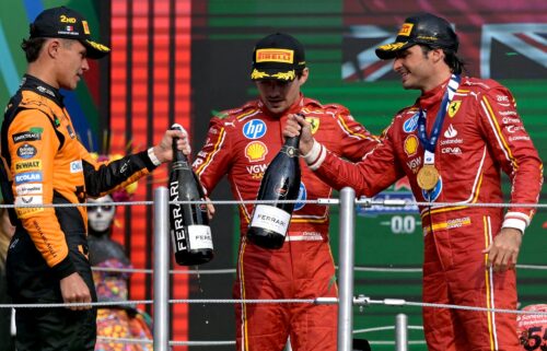 Sainz celebrates on the podium with Lando Norris and teammate Charles Leclerc.