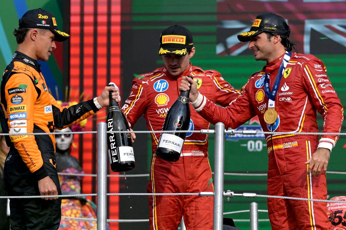 <i>Alfredo Estrella/AFP/Getty Images via CNN Newsource</i><br/>Sainz celebrates on the podium with Lando Norris and teammate Charles Leclerc.