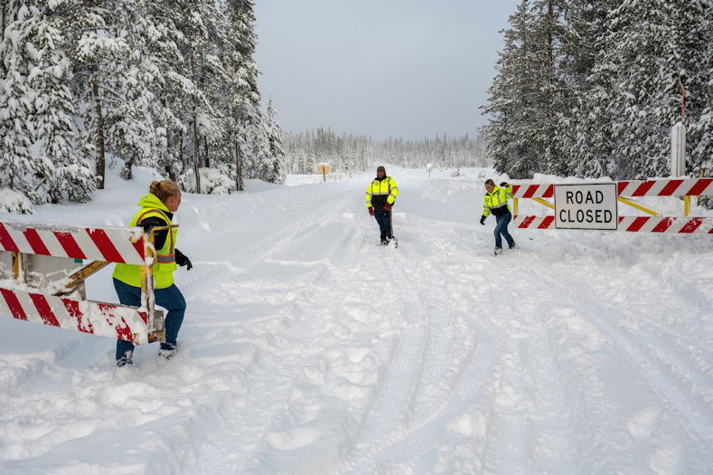 Deschutes County road crew members Jaci Krischik, Miguel Gonzales and Arionna Day close Cascade Lakes Highway gates for the season on Thursday. 