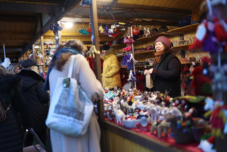 People shop for holiday items at the Christkindlmarket outside of Wrigley Field in December 2023 in Chicago.