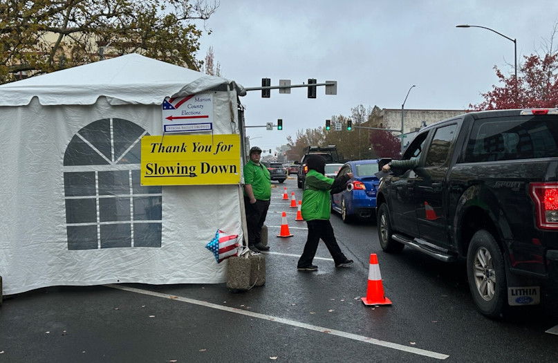 Voters drive through a ballot drop off site in front of the Marion County Courthouse in downtown Salem on Monday, Nov. 4, 2024.