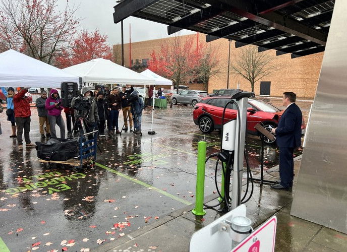 ODOT director Kris Strickler, right, speaks to media and state agency staff at Monday EV event at OMSI in Portland.