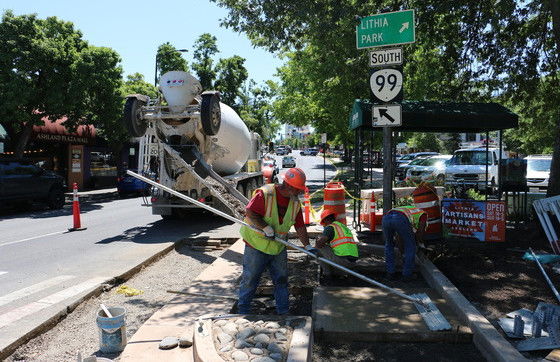 A contractor pours concrete for a new curb ramp in Ashland.