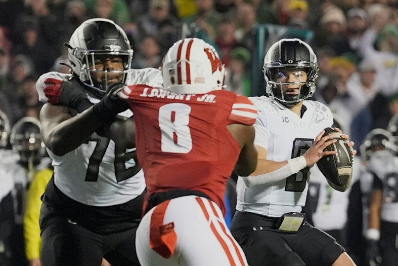 Oregon's Dillon Gabriel (8) looks to throw during the second half of an NCAA college football game against Wisconsin Saturday, Nov. 16, 2024, in Madison, Wis. Oregon won 16-13.