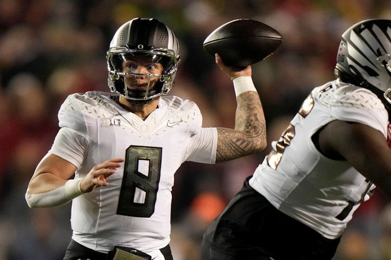 Oregon's Dillon Gabriel (8) thorws a pass during the first half of an NCAA college football game against Wisconsin Saturday, Nov. 16, 2024, in Madison, Wis.