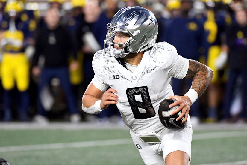 Oregon quarterback Dillon Gabriel scrambles out of the pocket against Michigan in the second half of Saturday's game in Ann Arbor, Mich. Oregon defeated Michigan 38-17. 