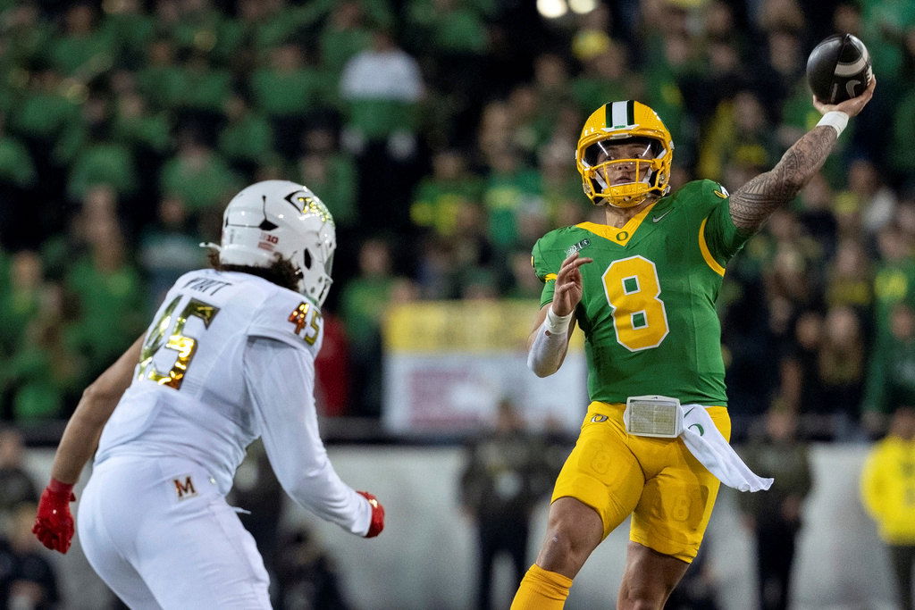 Oregon quarterback Dillon Gabriel (8) throws the ball as Maryland linebacker Kellan Wyatt (45) defends during the second half of an NCAA college football game on Saturday, Nov. 9, 2024, in Eugene. Oregon won 39-18.