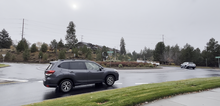 Driver enters the Reed Market Road/Bond Street/Brookswood Boulevard roundabout in SW Bend.