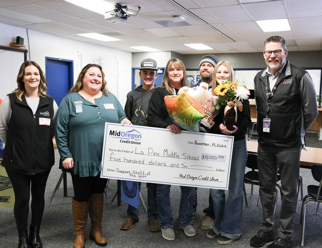 Bend-La Pine Schools Superintendent Steven Cook, right, with Excellence in Education Award recipient Tiffany Schreiber, center, with her husband Adam and their children Brady and Sydney. At left are Jessica Kidd and Tiffany Zeiler with MidOregon Credit Union.