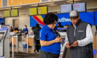 A Southwest Airlines employee assists a passenger during check-in at the Austin-Bergstrom International Airport in Texas.