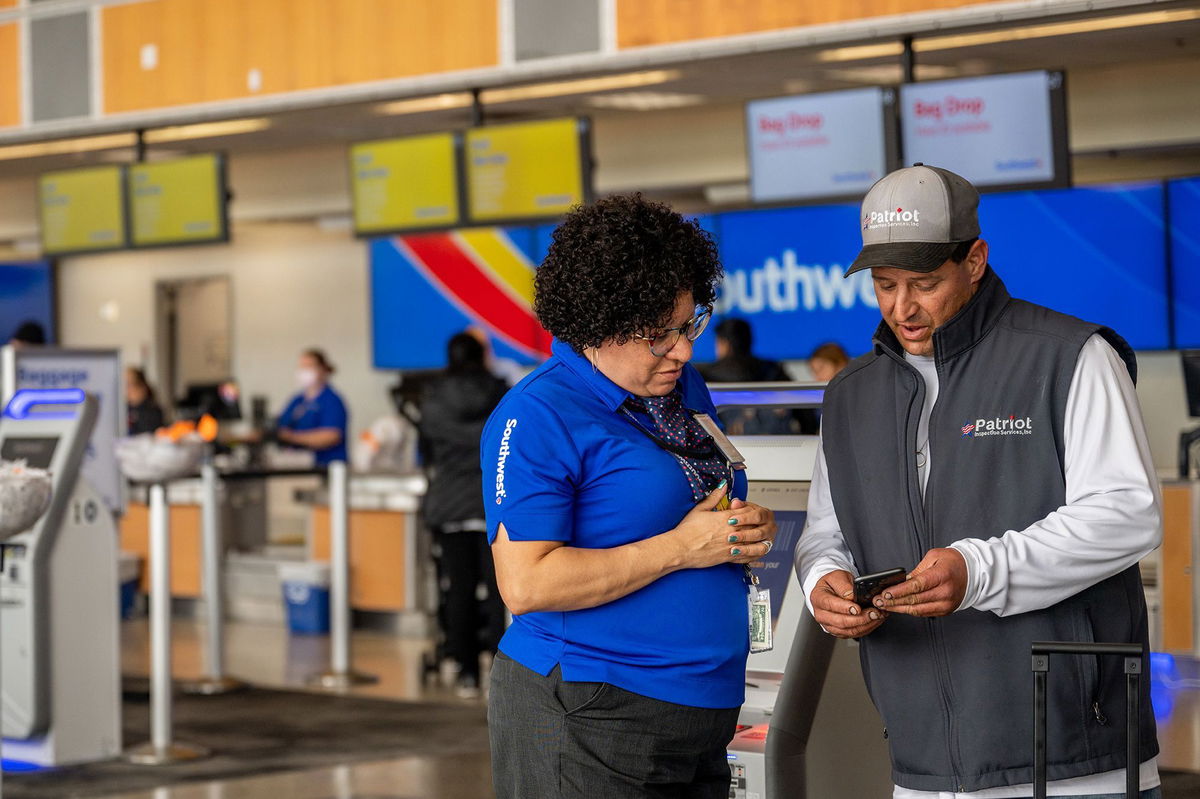 <i>Brandon Bell/Getty Images via CNN Newsource</i><br/>A Southwest Airlines employee assists a passenger during check-in at the Austin-Bergstrom International Airport in Texas.