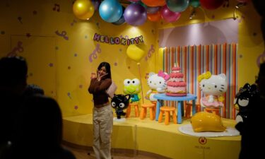 A fan poses for photos at a Hello Kitty-themed café in Mexico City.