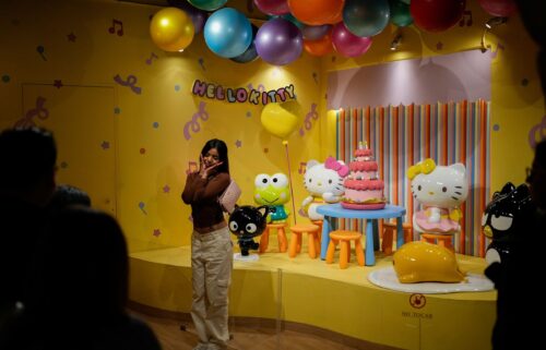 A fan poses for photos at a Hello Kitty-themed café in Mexico City.