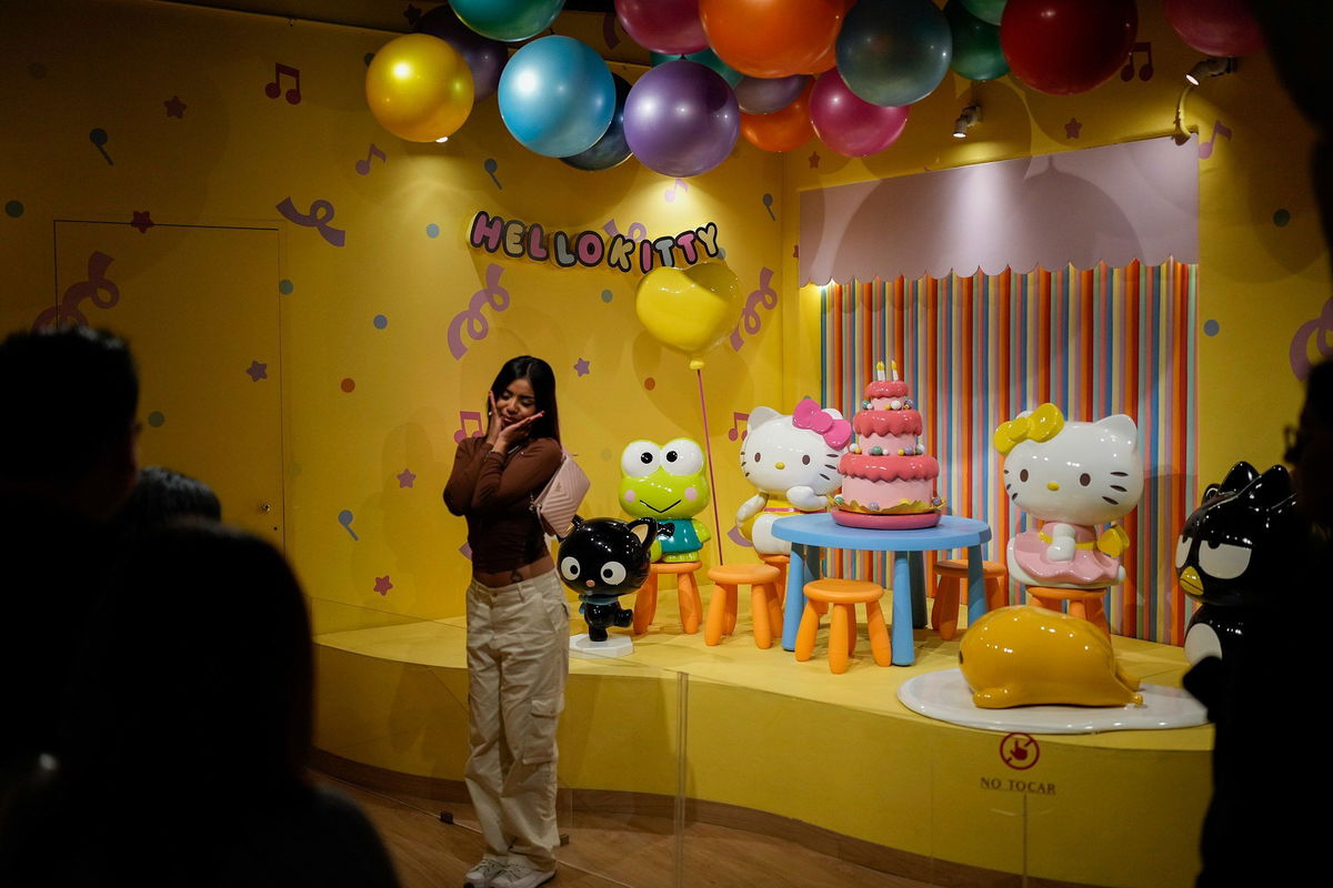 <i>Eduardo Verdugo/AP via CNN Newsource</i><br/>A fan poses for photos at a Hello Kitty-themed café in Mexico City.