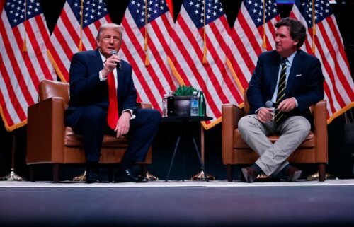 Former President Donald Trump sits down with Tucker Carlson during his Live Tour at the Desert Diamond Arena on October 31