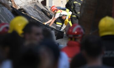 Rescue workers search for victims in the aftermath of a collapsed roof at a train station in Novi Sad