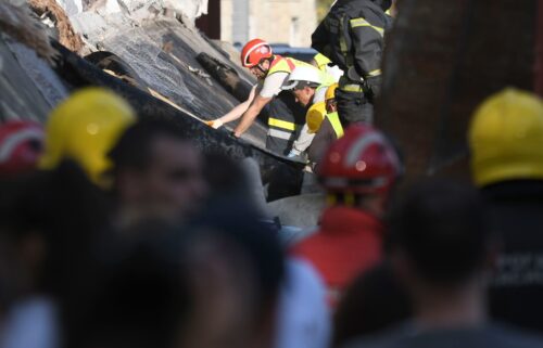 Rescue workers search for victims in the aftermath of a collapsed roof at a train station in Novi Sad