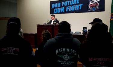 IAM District 751 president Jon Holden speaks to union members while announcing that they voted to reject a new contract offer from Boeing on October 23.